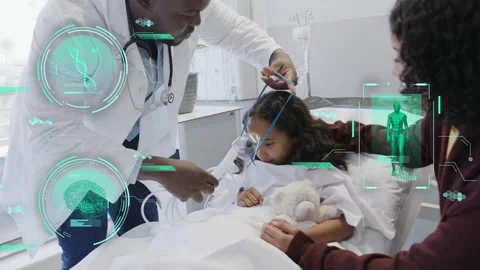 Doc grabbing mask, fitting tubing on kid while mom steadying for O2, with green Stock Footage 334013829