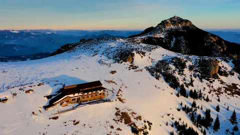 Dochia chalet and Toaca peak at sunrise in Ceahl?u Mountains National in wint Stock Footage 129951445