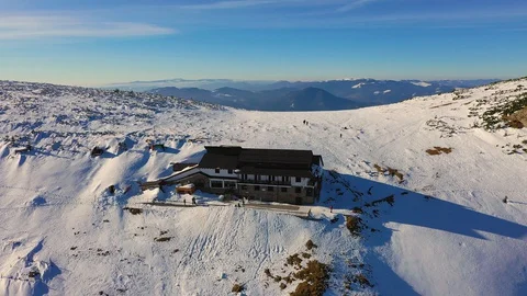 Dochia chalet and Toaca peak at sunrise in Ceahl?u Mountains National in wint Stock Footage 129951561