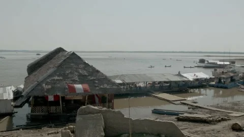 A dock at the Amazon river in Iquitos, Peru with a peruvian flag hanging Stock Footage 188912086