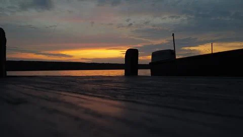 Dock and a boat in the sunset Stock Photos