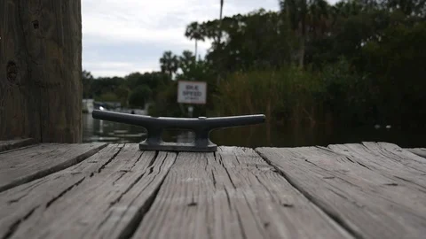Dock Cleat In Foreground From Low Angle with Idle Speed Sign in Bokeh Background 動画素材 110858190