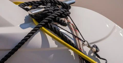 Dock cleat on the side of a boat in a small marina, an element of yachting eq Stock Photos