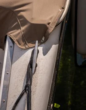 Dock cleat on the side of a boat in a small marina, an element of yachting eq Stock Photos