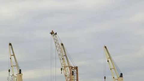 Dock Crane moving against cloudy sky Stock Footage 85040945