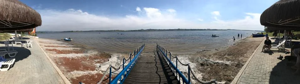 Dock down to beach at lake Stock Photos
