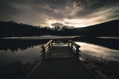 Dock overlooking a calm lake. Stock Photos