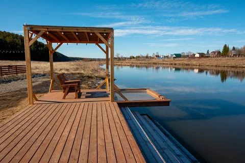 A dock with a picnic table and a bench on it Foto stock