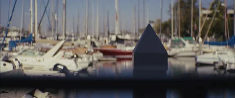 Dock Post in Focus with Blurred Boats in Marina Stock Footage 312764532