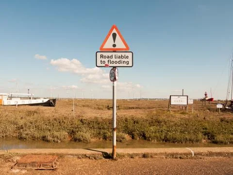 Dock road sign red triangle exclamation road liable to flooding Stock Photos