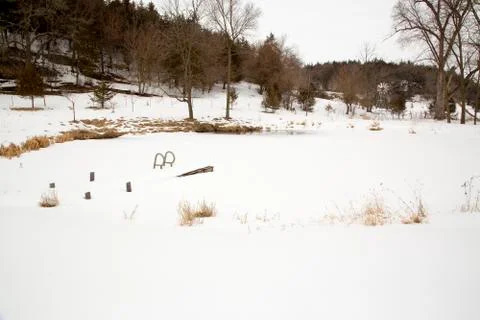Dock on a snowy pond. Stock Photos