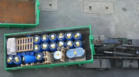 In dock truck loads on itself container with barrels Stock Footage 11546945