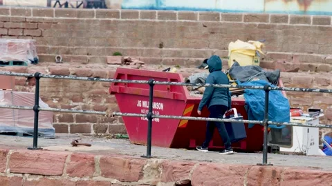 Dock Worker in Hooded Jacket Walking Past Industrial Equipment Stock Footage 321854243