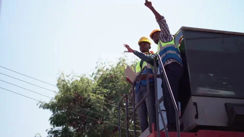 Dock worker team on container stackers control loading containers box from cargo Stock Footage 166879610