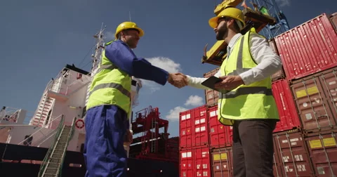 Dock workers discuss logistics at the harbor on a digital tablet. Stock Footage 55026722