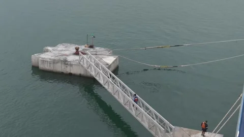 Dock workers removing mooring lines allowing cruse ship to makes its next port Stock Footage 307916545