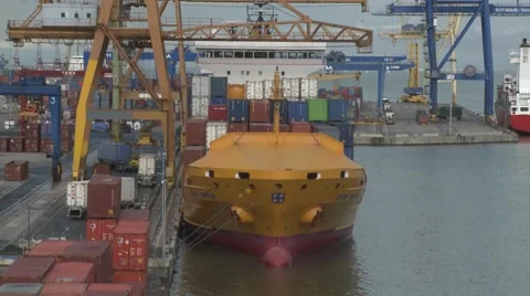 Docked container ship being loaded with containers in the harbor Stock Footage 63811481