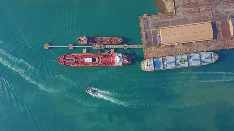 Docked vessel in port offloading goods and cargo. Stock Footage 99212242
