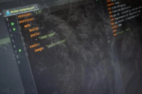 Docker compose Hello World code on screen blurry background image Stock Photos