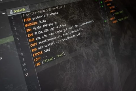 Docker file Hello World code on screen Stock Photos