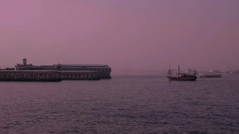 Docking in Hong Kong Central Ferry Pier in a purple evening dusk Stock Footage 129872290