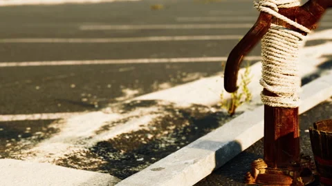 Docking post stands by the side of an empty parking lot during the day Stock Footage 340613971