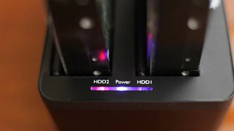 Docking station for hard disk while working.Copying data to hard disk computer Stock Footage 138646645