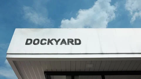 Dockyard word sign displayed on building with blue sky background Stock Footage 318626989