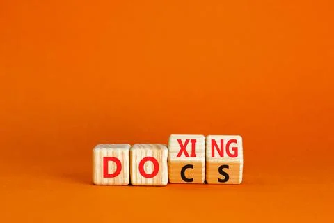 Docs or doxing symbol. Concept words Docs Doxing on wooden block. Beautiful.. Stock Photos