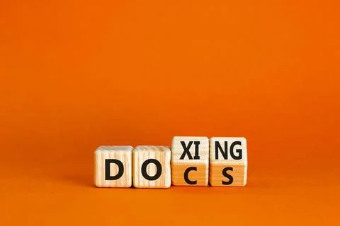 Docs or doxing symbol. Concept words Docs Doxing on wooden block. Beautiful.. Stock Photos