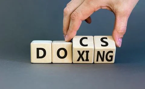 Docs or doxing symbol. Concept words Docs Doxing on wooden block. Beautiful.. Stock Photos