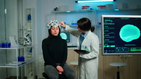 Doctor analysing brain scan using tablet, examining evolution of disease Stock Footage 149135326