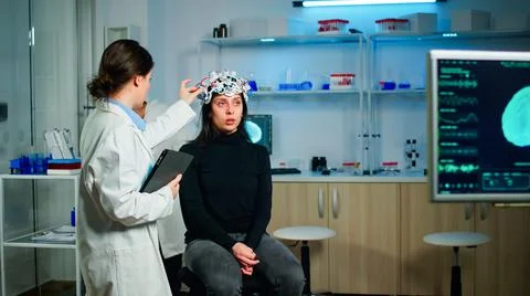 Doctor analysing brain scan using tablet, examining evolution of disease Stock Photos