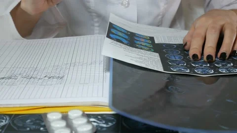 The doctor analyzes the data from the X-ray Stock Footage 87480066