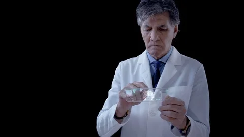 Doctor analyzing MRI Brain Scan Images on a futuristic device. Alpha matte. Video stock 106695880