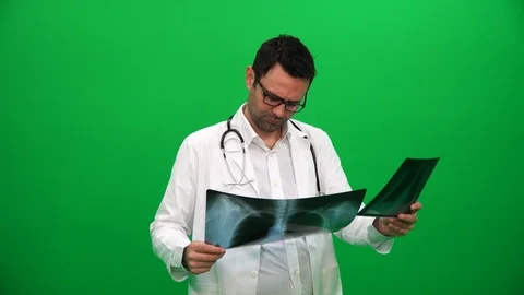 Doctor Analyzing X-Ray on Green Screen Stock Footage 88652048