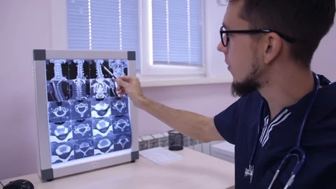 Doctor analyzing x-ray tomography medical data and showing patient symptoms Stock Footage 123162143