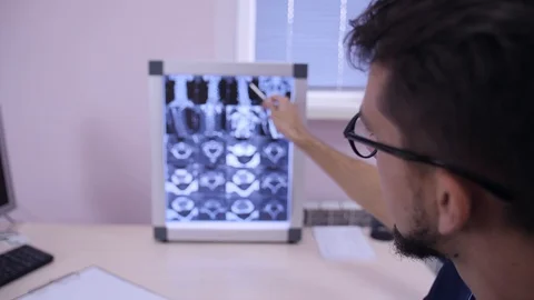 Doctor analyzing x-ray tomography medical data and showing patient symptoms Stock Footage 123162164