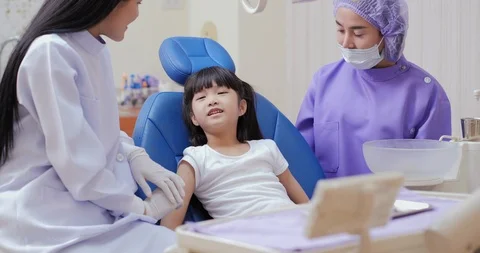 Doctor and assistance take care to child for problem. Stock Footage 117352453