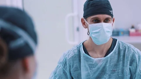 Doctor and an assistant in the operating room for surgical venous vascular Stock Footage 72048013