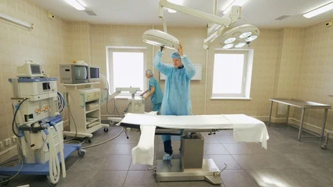 Doctor and assistant preparing to work in operating room in hospital Stock Footage 90395156