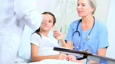 Doctor and Nurse Examining Young Patient in Hospital Stock Footage