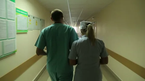The doctor and the nurse go on a corridor. Stock Footage 59590244