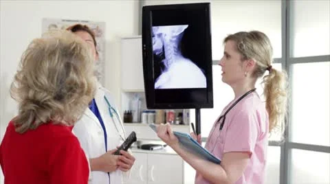 Doctor and nurse showing patient xray Stock Footage