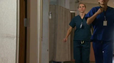 Doctor and nurses running in hospital corridor Stock Footage