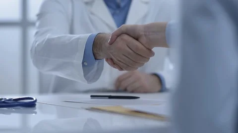 Doctor and patient shaking hands Stock Footage