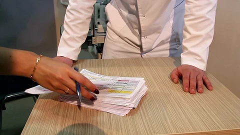 Doctor and a stack of test results Stock Footage 99598618