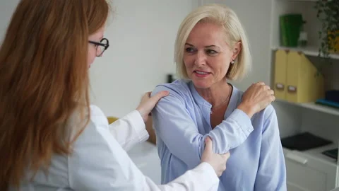 Doctor at appointment with client traumatologist bends arm Spbd Stock Footage 159500644
