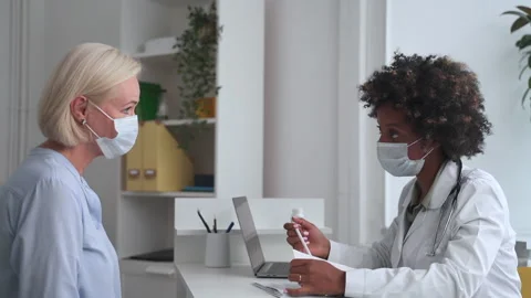 Doctor appointment at covid-19 lockdown woman checks results Spbas Stock Footage 159793680