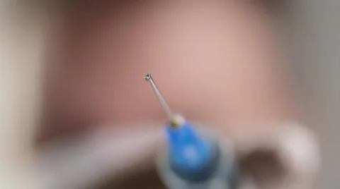 Doctor approaches with injection syringe Stock Footage 35110153